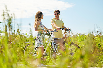 Image showing happy couple with bicycles at country