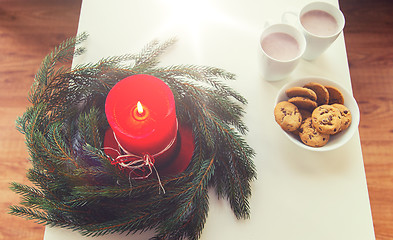 Image showing close up of christmas wreath with candle on table