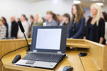 Image showing Laptop computer and microphotone at podium on business conference event.