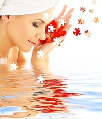 Image showing lady with red petals in water