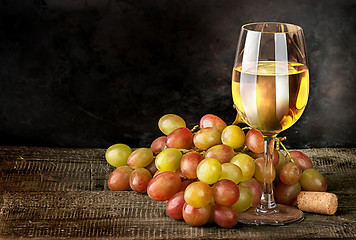 Image showing Glass of white wine with grapes