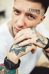 Image showing Handsome man in tattoos posing