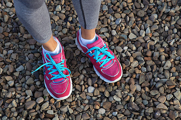 Image showing pink sports shoes on gravel