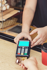 Image showing Person paying bill in cafe