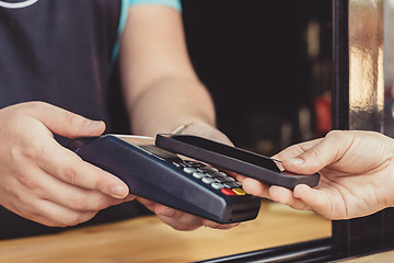 Image showing Person paying pay through smartphone using NFC