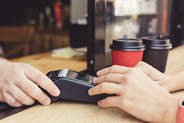 Image showing Person using pos terminal at the cafe