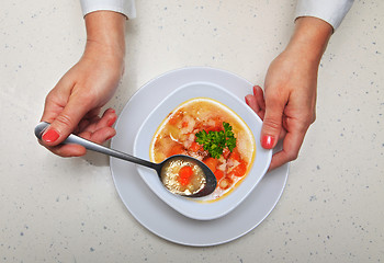 Image showing woman holds spoon with soup