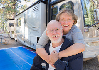 Image showing Senior Couple In Front of Their Beautiful RV At The Campground.