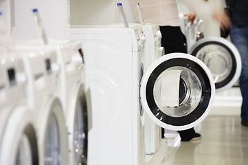 Image showing washing machines in appliance store and defocused buyer