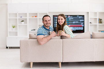 Image showing young handsome couple enjoying morning coffee