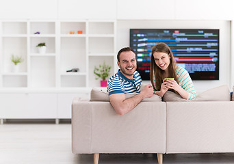 Image showing young handsome couple enjoying morning coffee