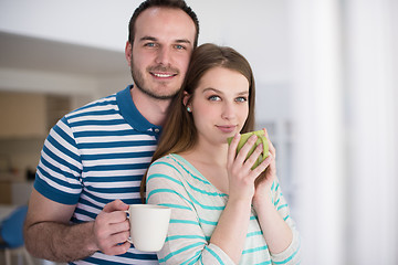 Image showing young handsome couple enjoying morning coffee