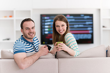 Image showing young handsome couple enjoying morning coffee