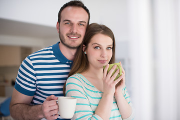 Image showing young handsome couple enjoying morning coffee