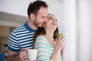 Image showing young handsome couple enjoying morning coffee