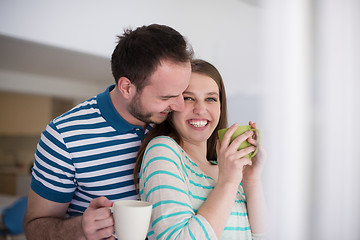 Image showing young handsome couple enjoying morning coffee