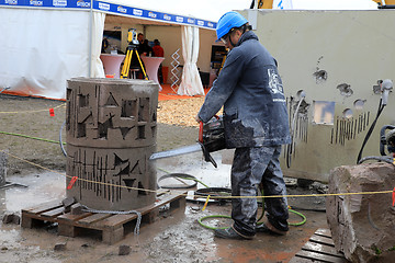 Image showing Man Cuts Concrete with ICS Chain Saw