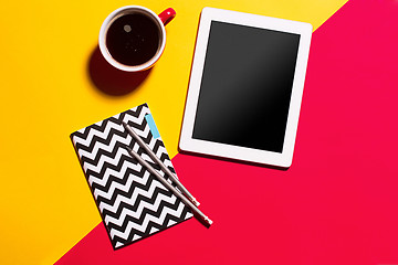 Image showing Modern red office desk table with smartphone and cup of coffee.