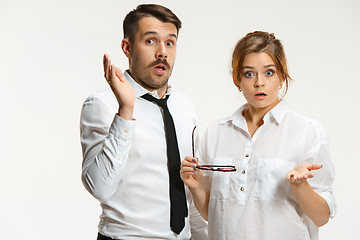 Image showing The business man and woman communicating on a gray background