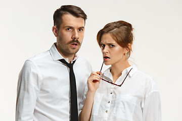 Image showing The business man and woman communicating on a gray background