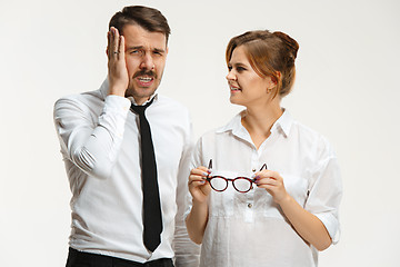 Image showing The business man and woman communicating on a gray background