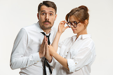 Image showing The business man and woman communicating on a gray background