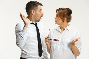 Image showing The business man and woman communicating on a gray background