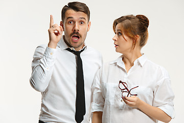 Image showing The business man and woman communicating on a gray background