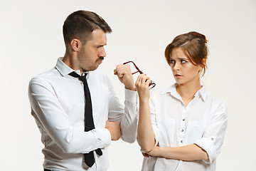 Image showing The business man and woman communicating on a gray background