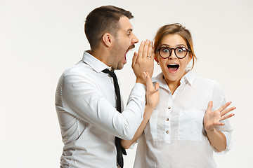 Image showing The business man and woman communicating on a gray background