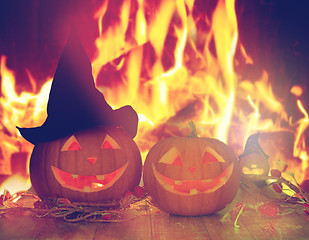 Image showing carved halloween pumpkins on table over fire