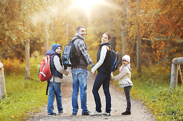 Image showing happy family with backpacks hiking walking