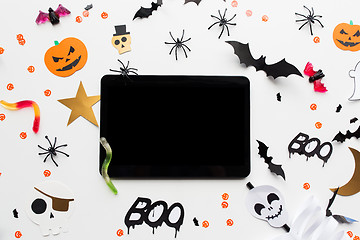 Image showing tablet pc, halloween party decorations and candies