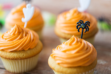 Image showing cupcakes with halloween decorations on table