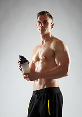 Image showing young man or bodybuilder with protein shake bottle