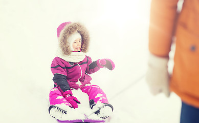 Image showing happy little kid on sled outdoors in winter