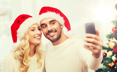 Image showing couple taking selfie with smartphone at christmas