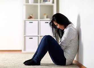 Image showing unhappy woman crying on floor at home