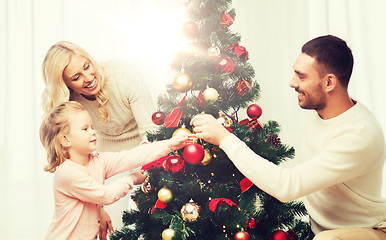 Image showing happy family decorating christmas tree at home