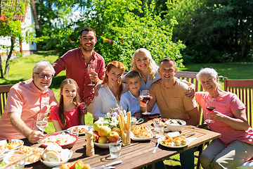 Image showing happy family having dinner or summer garden party