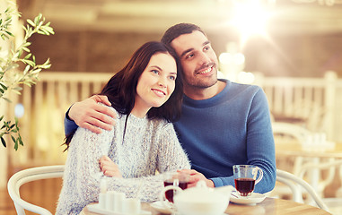 Image showing happy couple drinking tea at restaurant