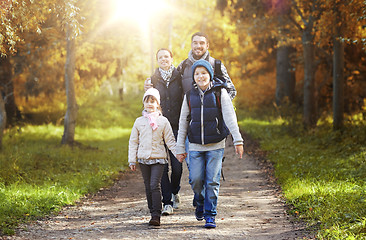 Image showing happy family with backpacks hiking