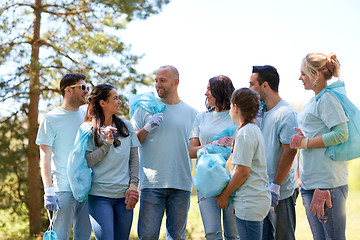 Image showing volunteers with garbage bags walking outdoors