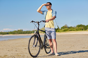 Image showing happy man with bicycle on summer beach