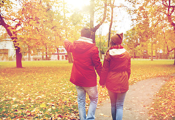 Image showing happy young couple walking in autumn park