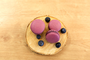 Image showing blueberry macarons on wooden stand