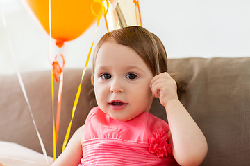 Image showing happy baby girl in crown on birthday party at home