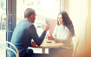 Image showing happy couple drinking tea and coffee at cafe