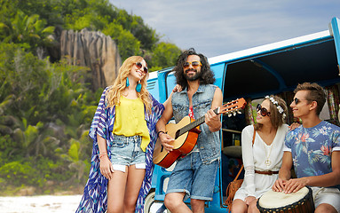 Image showing hippie friends playing music at minivan on island