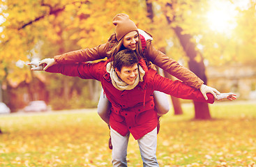 Image showing happy young couple having fun in autumn park